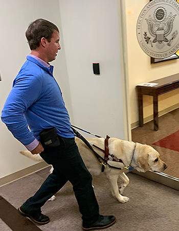 Heading into work, Hogan zeroes in on the front door of the U.S. Election Assistance Commission. The silver seal of the Commission is seen on the glass door.